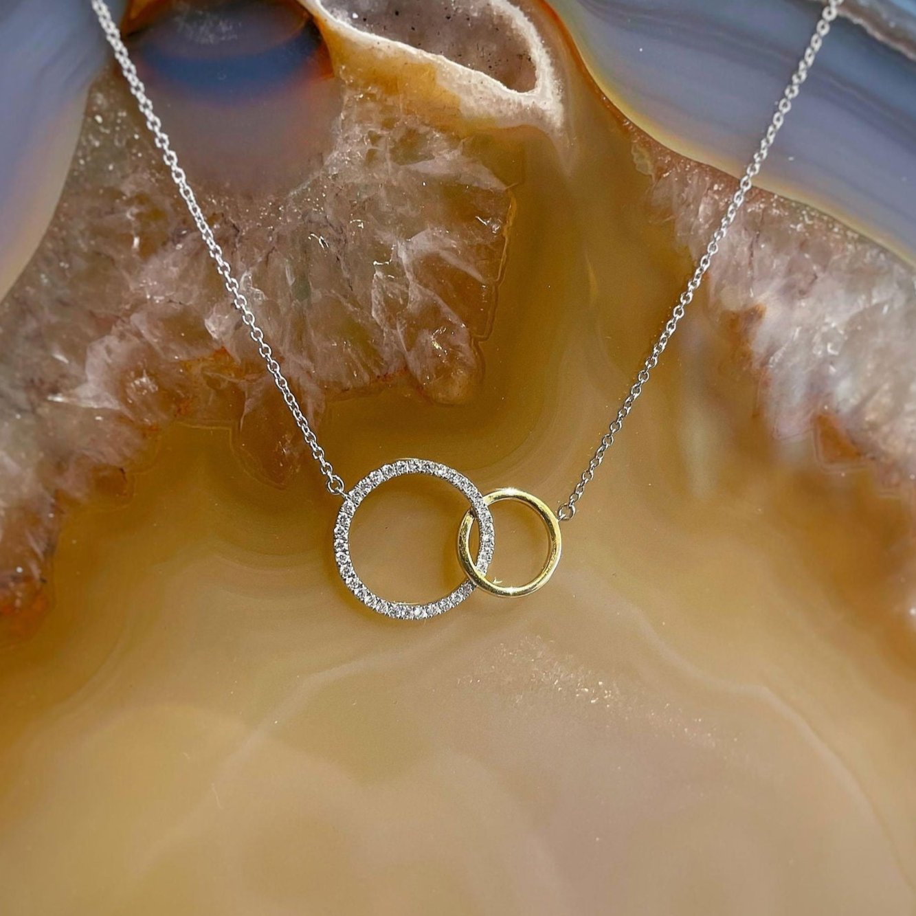 Photo of Linked Loop Diamond Necklace in a decorative scene, designed by , available at Plumb Gold & Plumb Silver
