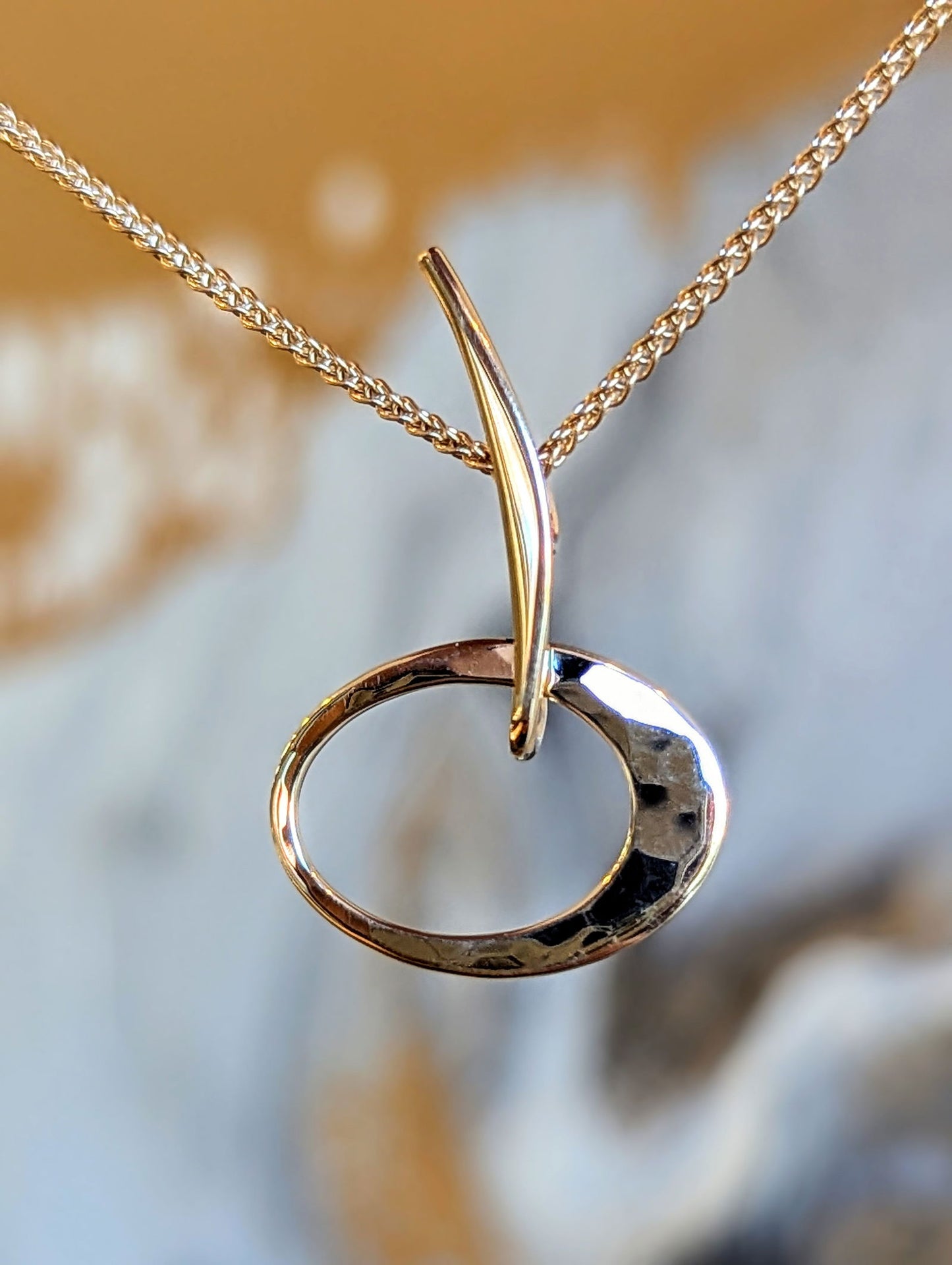 Photo of "Petite Elliptical" Pendant in a decorative scene, designed by , available at Plumb Gold & Plumb Silver