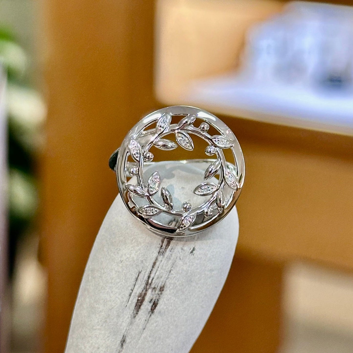 Photo of Vine Wreath Ring in a decorative scene, designed by -, available at Plumb Gold & Plumb Silver