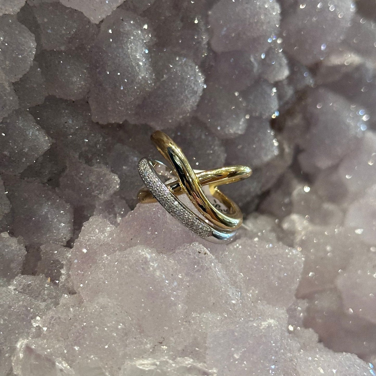 Photo of Abstract Diamond Cross Ring in a decorative scene, designed by , available at Plumb Gold & Plumb Silver