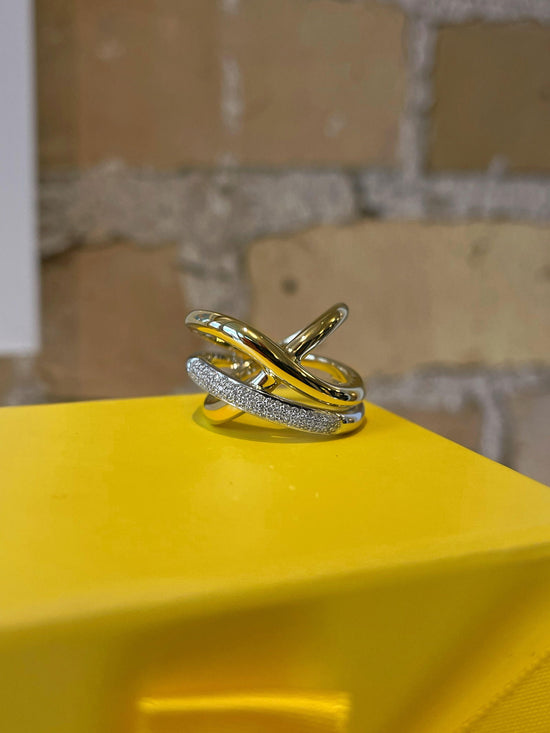Photo of Abstract Diamond Cross Ring in a decorative scene, designed by , available at Plumb Gold & Plumb Silver