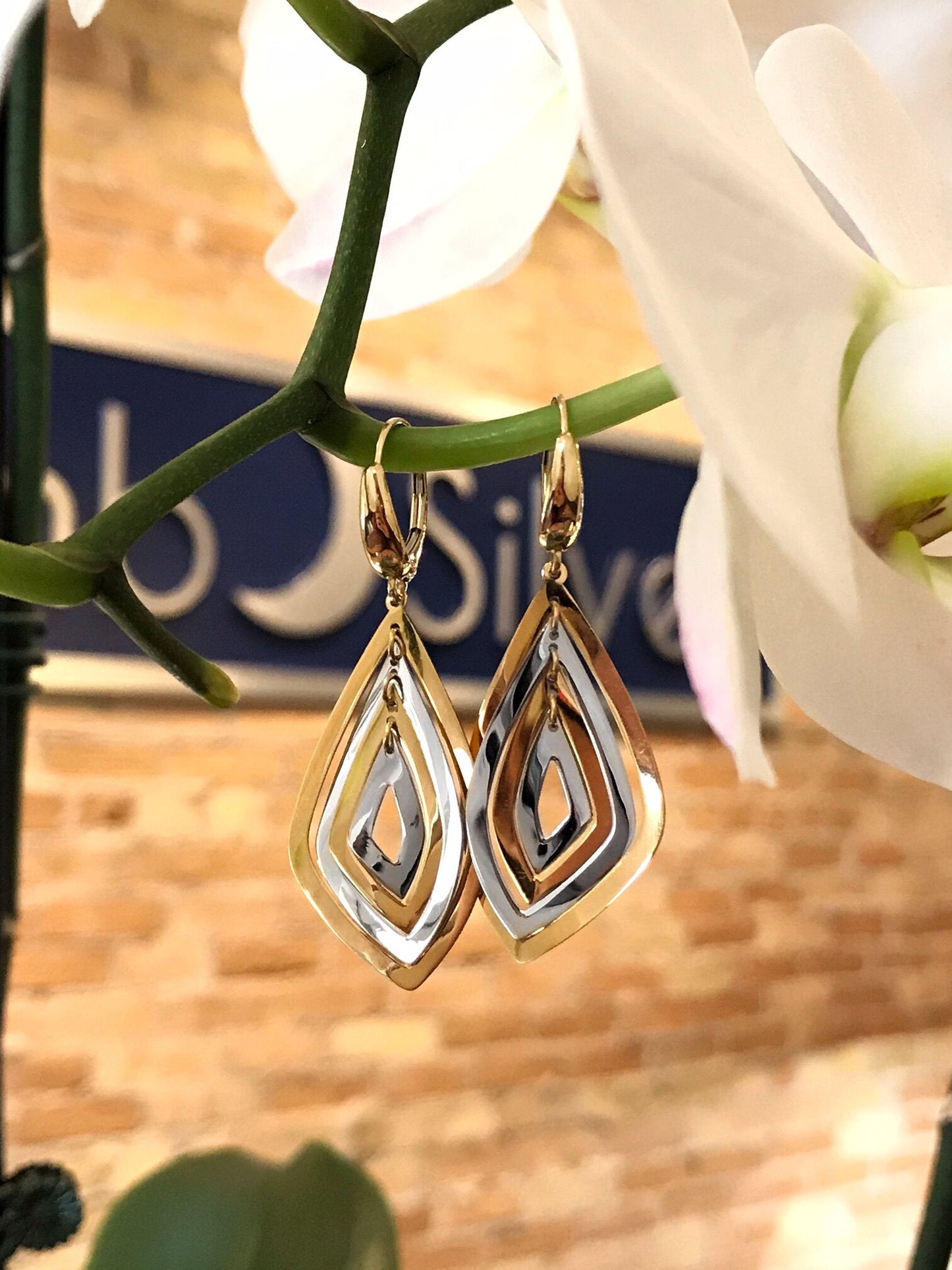 Photo of Abstract Marquise Dangles in a decorative scene, designed by , available at Plumb Gold & Plumb Silver
