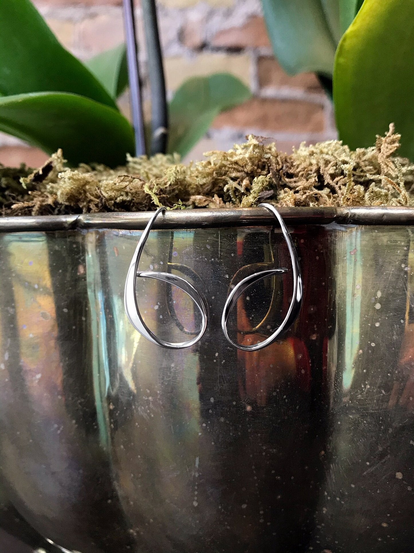 Photo of "Allegro" Earrings in a decorative scene, designed by , available at Plumb Gold & Plumb Silver