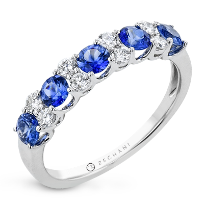 Photo of Alternating Blue Sapphire and Diamond Ring in a decorative scene, designed by , available at Plumb Gold & Plumb Silver