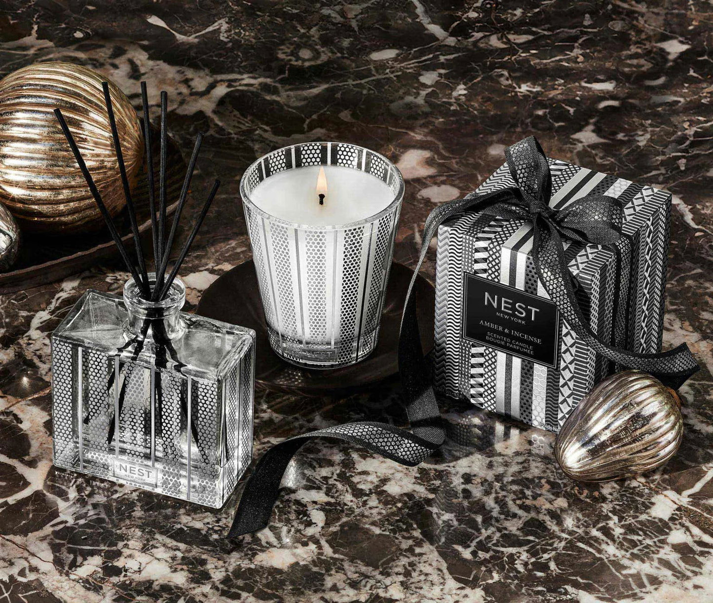Photo of Amber and Incense Candle in a decorative scene, designed by , available at Plumb Gold & Plumb Silver