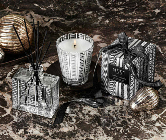 Photo of Amber and Incense Candle in a decorative scene, designed by , available at Plumb Gold & Plumb Silver