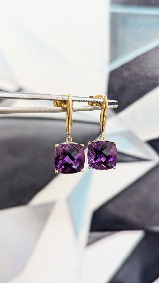Photo of Amethyst Drop Earrings in a decorative scene, designed by , available at Plumb Gold & Plumb Silver