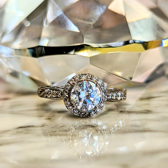 Photo of "Antoinette" Halo Filigree Engagement Mounting in a decorative scene, designed by , available at Plumb Gold & Plumb Silver