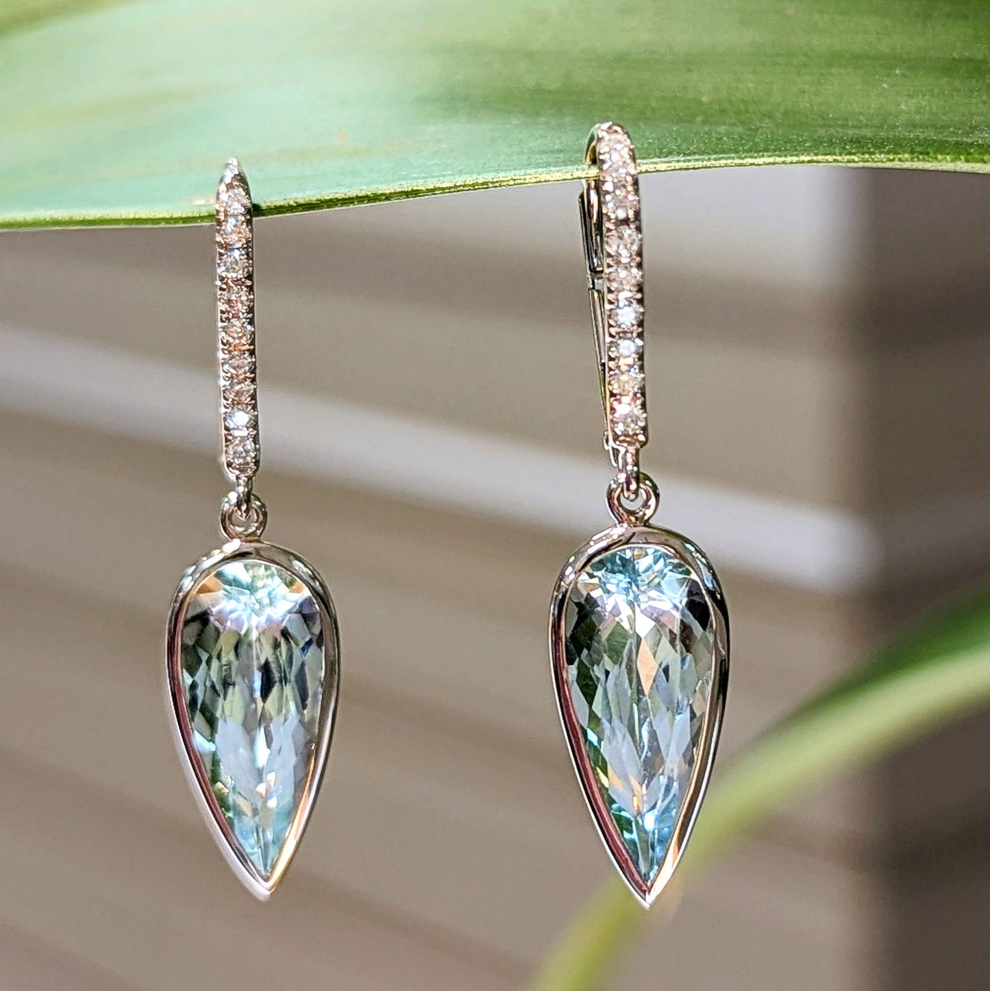 Photo of Aquamarine Pear Drop Earring in a decorative scene, designed by , available at Plumb Gold & Plumb Silver