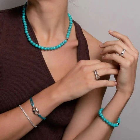 Photo of Beaded Turquoise Necklace in a decorative scene, designed by , available at Plumb Gold & Plumb Silver