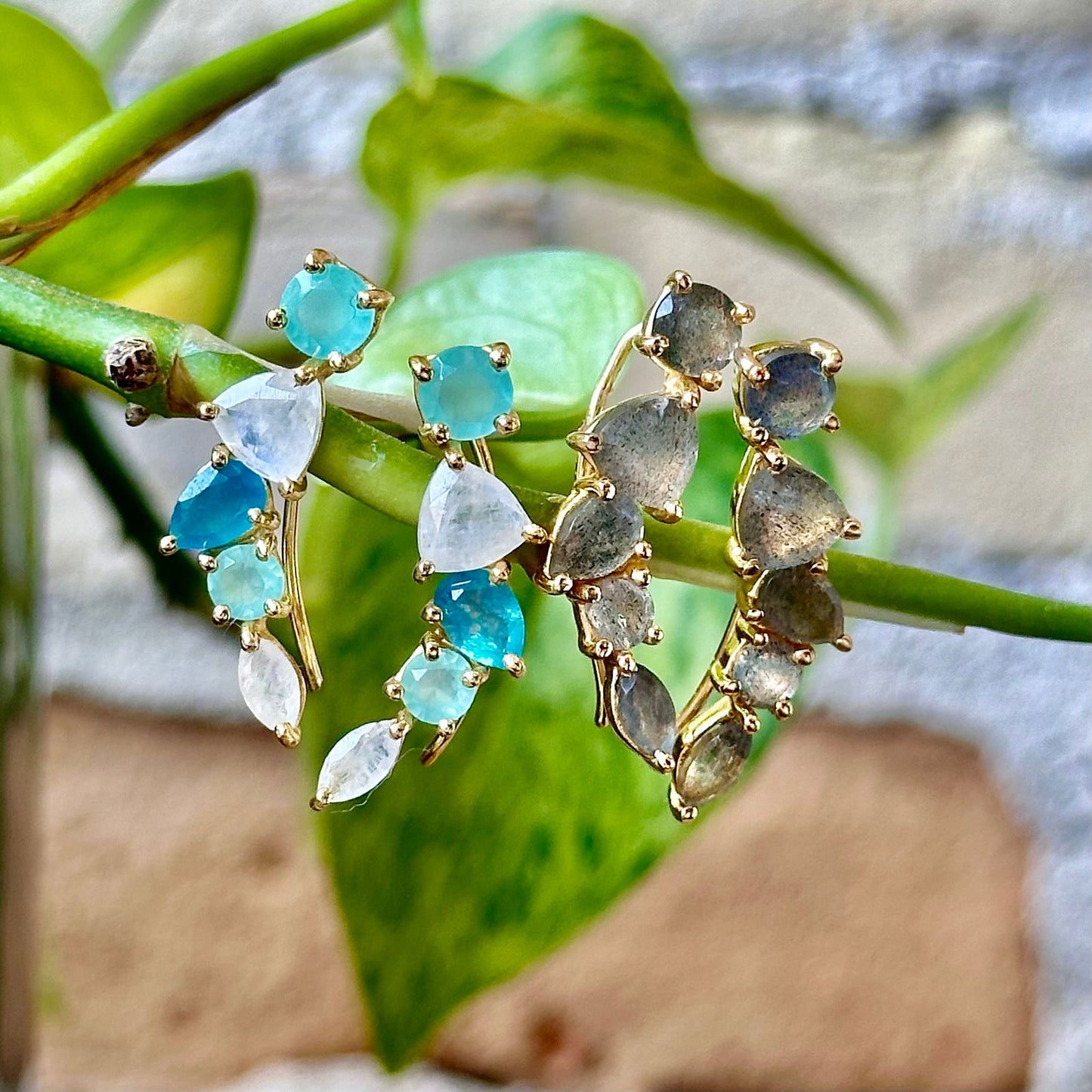 Photo of "Bella" Mixed Shape Dangle in a decorative scene, designed by -, available at Plumb Gold & Plumb Silver