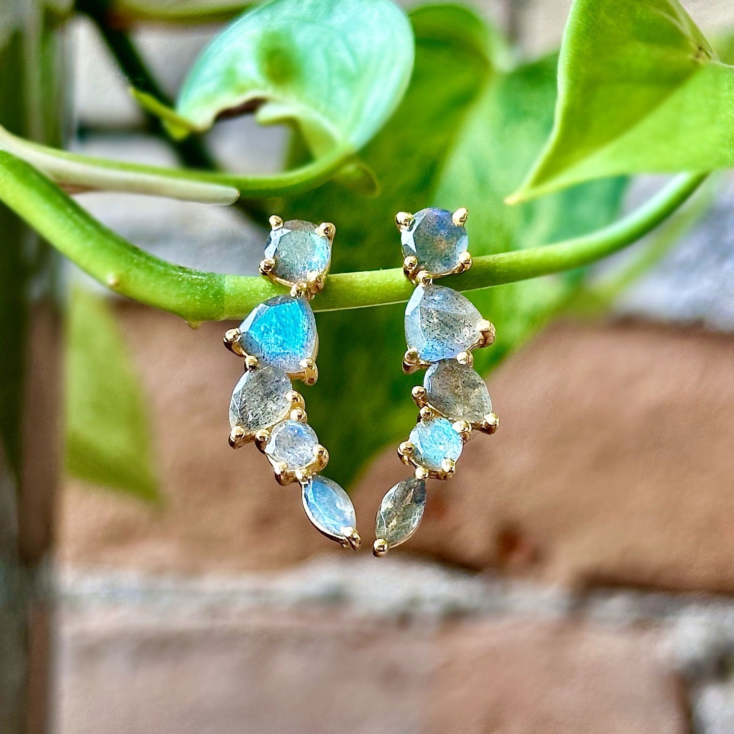 Photo of "Bella" Mixed Shape Dangle in a decorative scene, designed by -, available at Plumb Gold & Plumb Silver