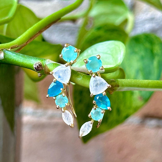 Photo of "Bella" Mixed Shape Dangle in a decorative scene, designed by -, available at Plumb Gold & Plumb Silver