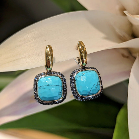 Photo of Bezel CZ Pave Halo Earrings in a decorative scene, designed by , available at Plumb Gold & Plumb Silver
