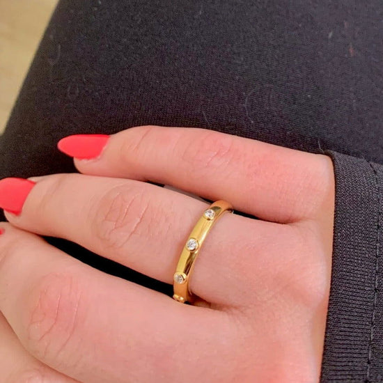 Photo of Bezel Station Stackable Ring in a decorative scene, designed by , available at Plumb Gold & Plumb Silver