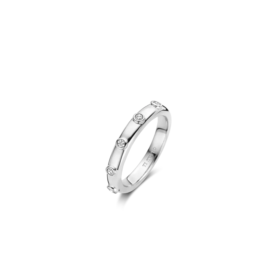 Photo of Bezel Station Stackable Ring in a decorative scene, designed by , available at Plumb Gold & Plumb Silver