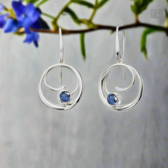 Photo of "Bindu" Earrings in a decorative scene, designed by , available at Plumb Gold & Plumb Silver