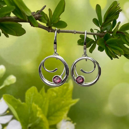 Photo of "Bindu" Earrings in a decorative scene, designed by , available at Plumb Gold & Plumb Silver
