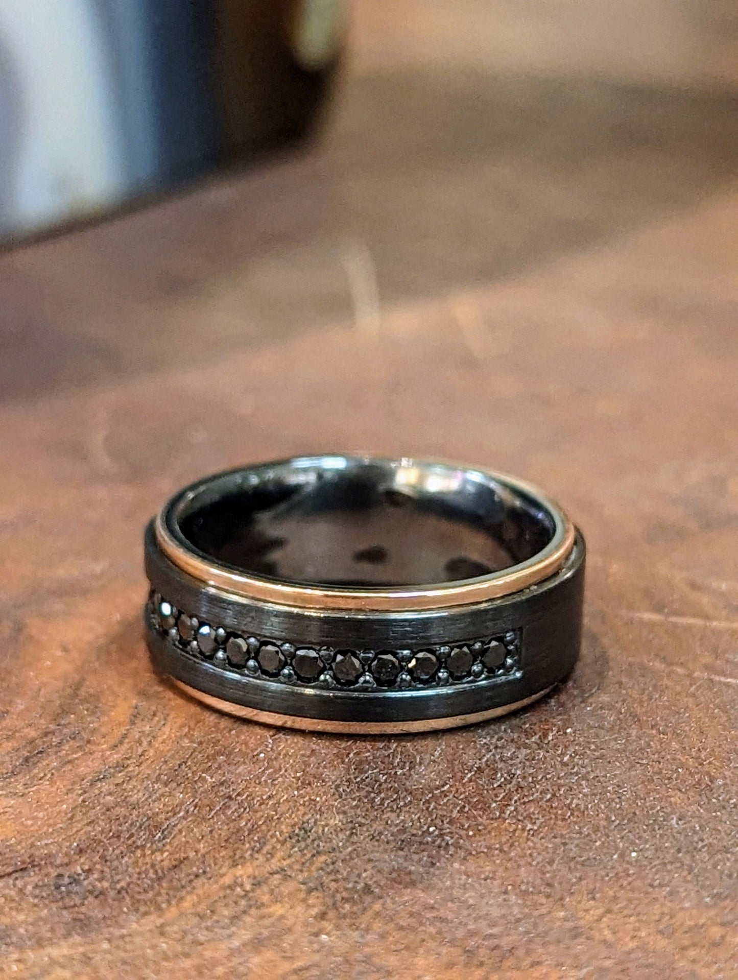 Photo of Black Diamond Zirconium Ring in a decorative scene, designed by , available at Plumb Gold & Plumb Silver