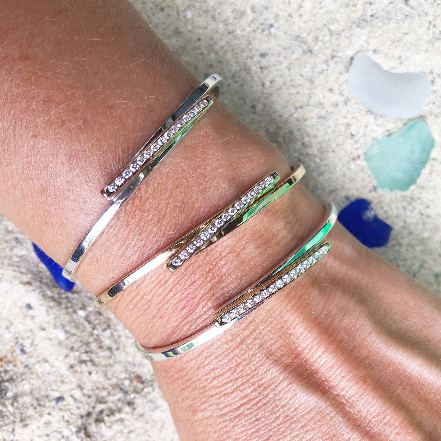 Photo of "Bling Swing" Bangle in a decorative scene, designed by , available at Plumb Gold & Plumb Silver