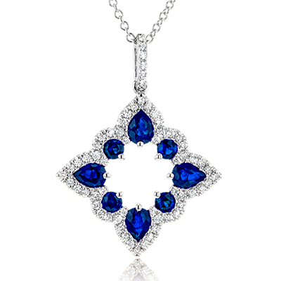Photo of Blue Sapphire Open Shape Necklace in a decorative scene, designed by , available at Plumb Gold & Plumb Silver