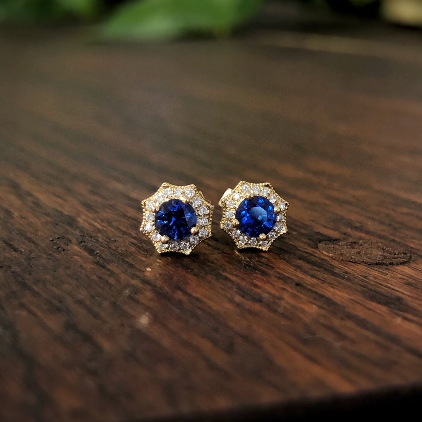Photo of Blue Sapphire and Diamond Web Studs in a decorative scene, designed by , available at Plumb Gold & Plumb Silver