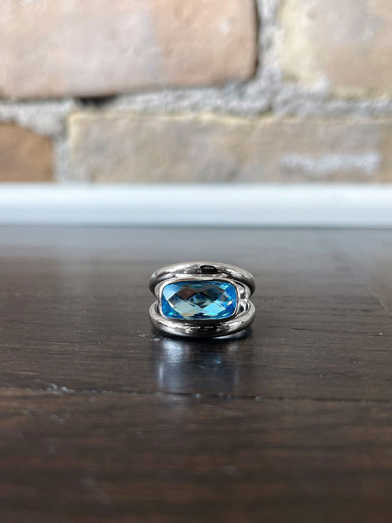 Photo of Blue Topaz Chain Ring in a decorative scene, designed by , available at Plumb Gold & Plumb Silver