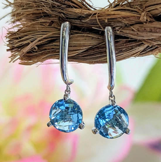 Photo of Blue Topaz Checkerboard Dangles in a decorative scene, designed by , available at Plumb Gold & Plumb Silver