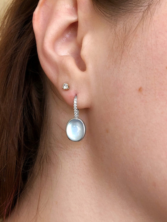 Photo of Blue Topaz Over Mother of Pearl Hoop Dangle in a decorative scene, designed by , available at Plumb Gold & Plumb Silver