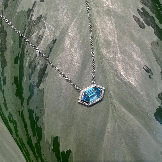 Photo of Blue Topaz Pendant in a decorative scene, designed by , available at Plumb Gold & Plumb Silver