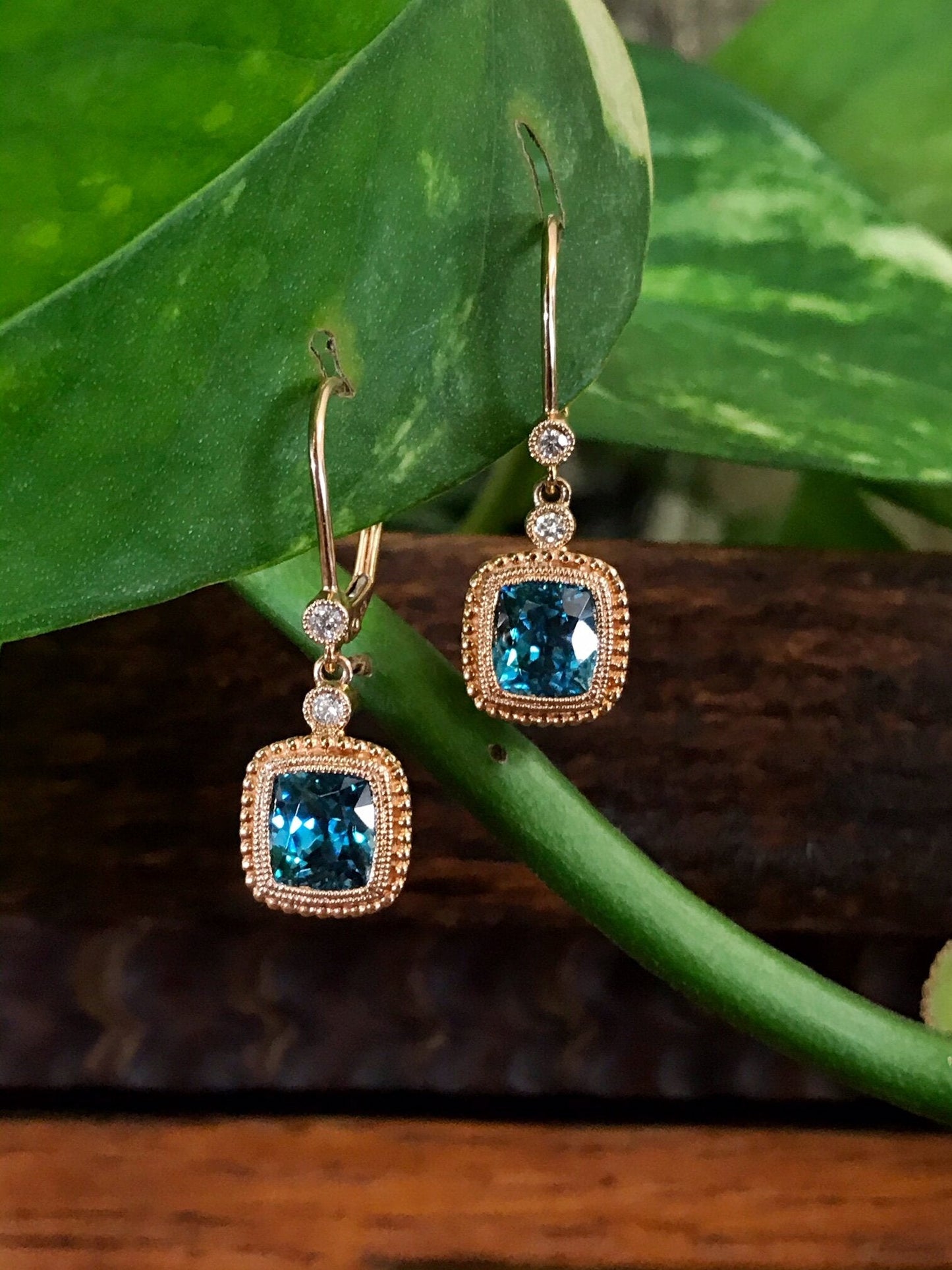 Photo of Blue Zircon Dangles in a decorative scene, designed by , available at Plumb Gold & Plumb Silver