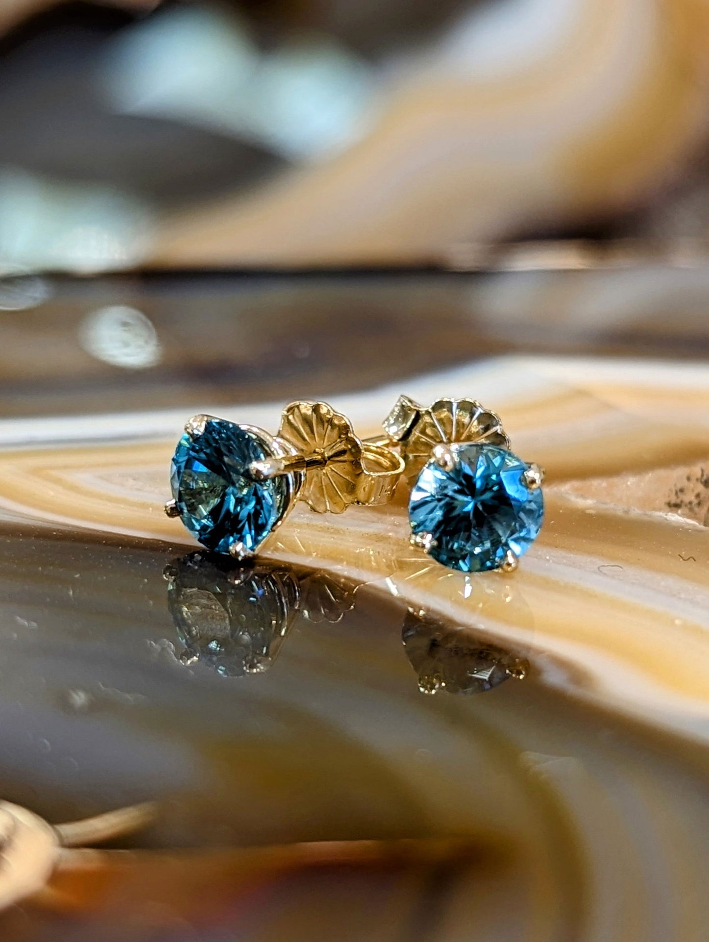 Photo of Blue Zircon Studs in a decorative scene, designed by , available at Plumb Gold & Plumb Silver