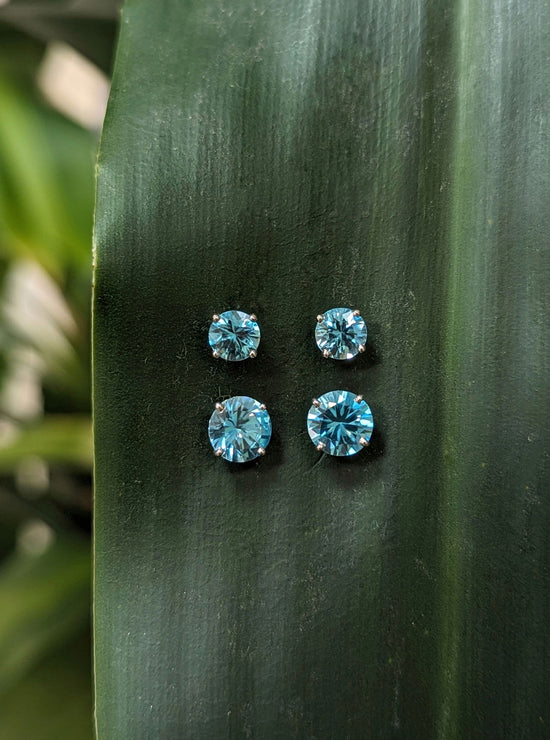 Photo of Blue Zircon Studs in a decorative scene, designed by , available at Plumb Gold & Plumb Silver