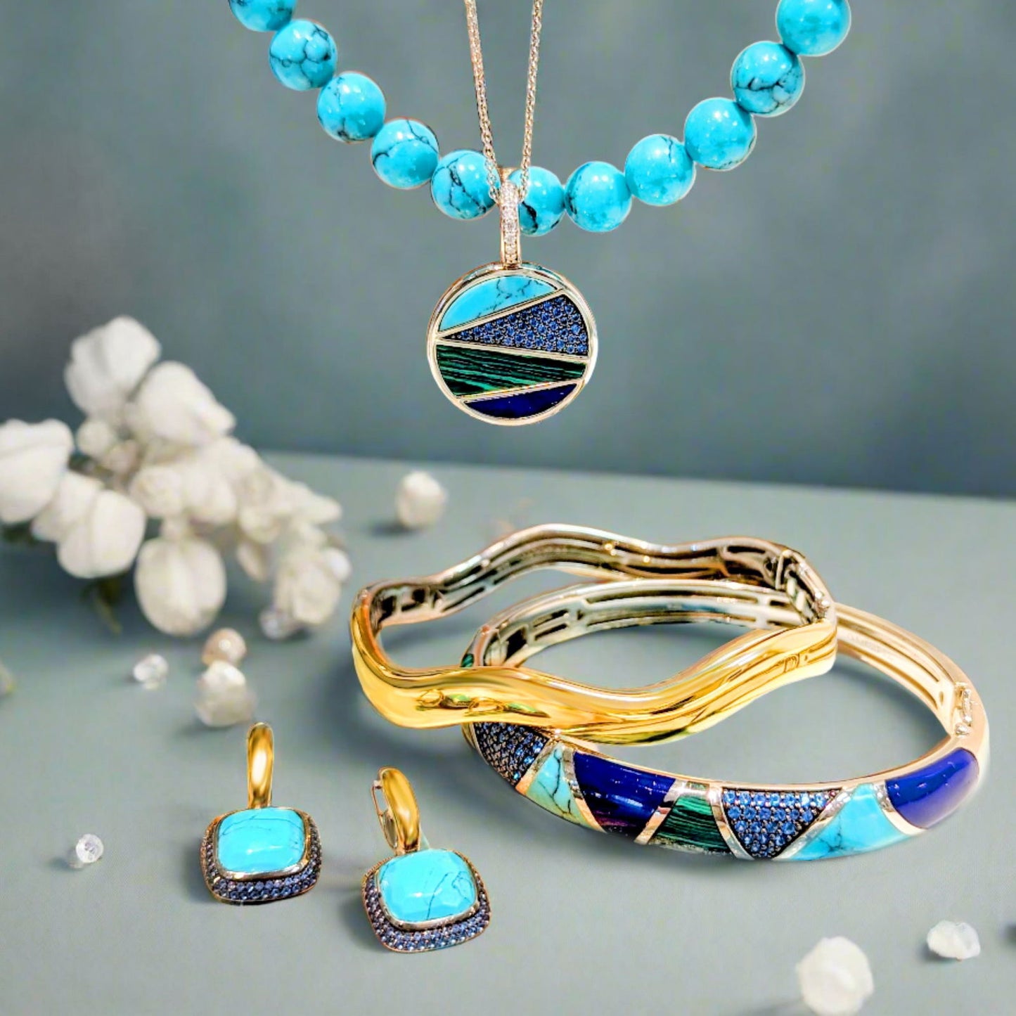 Photo of Blue and Green Inlay Bracelet in a decorative scene, designed by , available at Plumb Gold & Plumb Silver