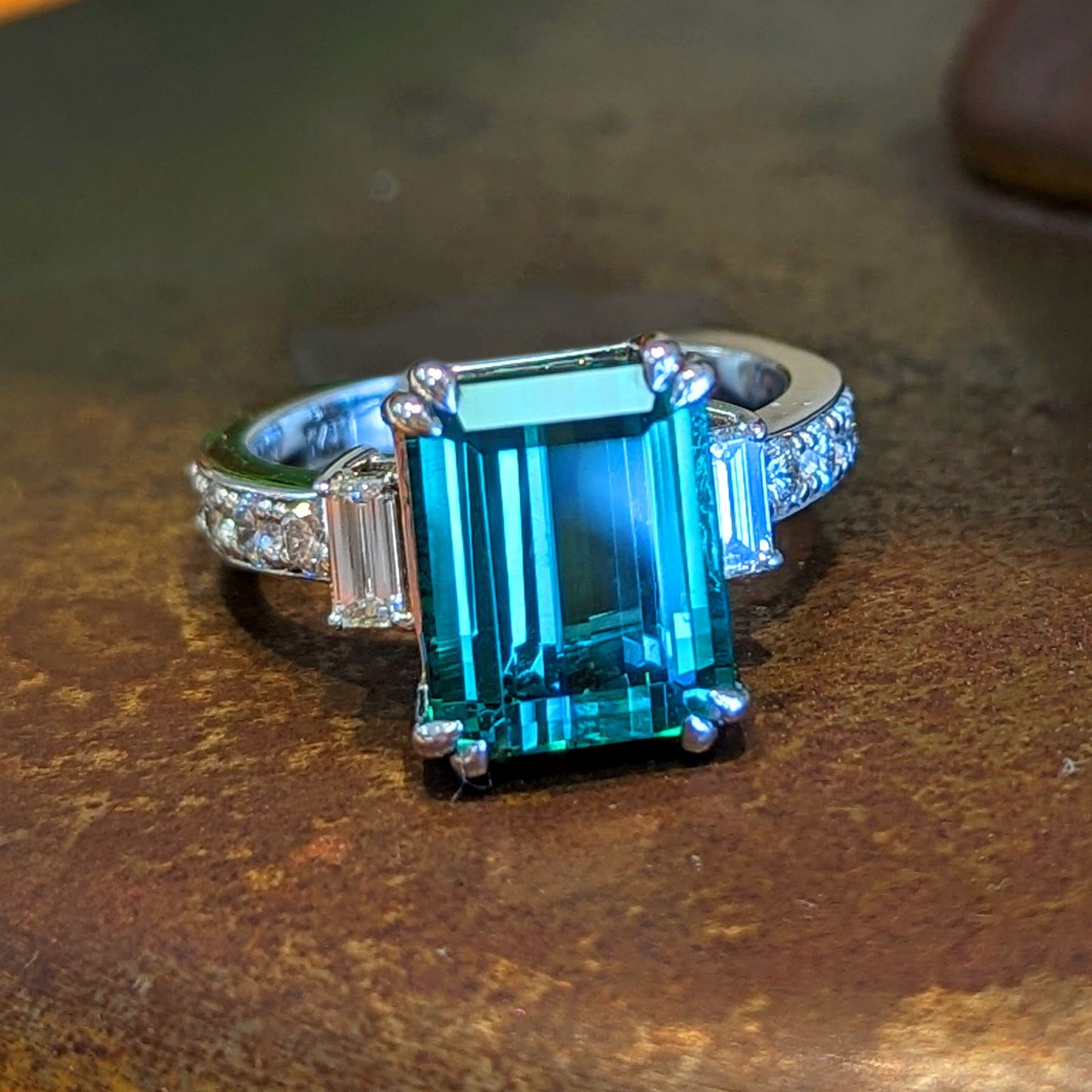 Photo of Bold Emerald Cut Tourmaline Ring in a decorative scene, designed by , available at Plumb Gold & Plumb Silver