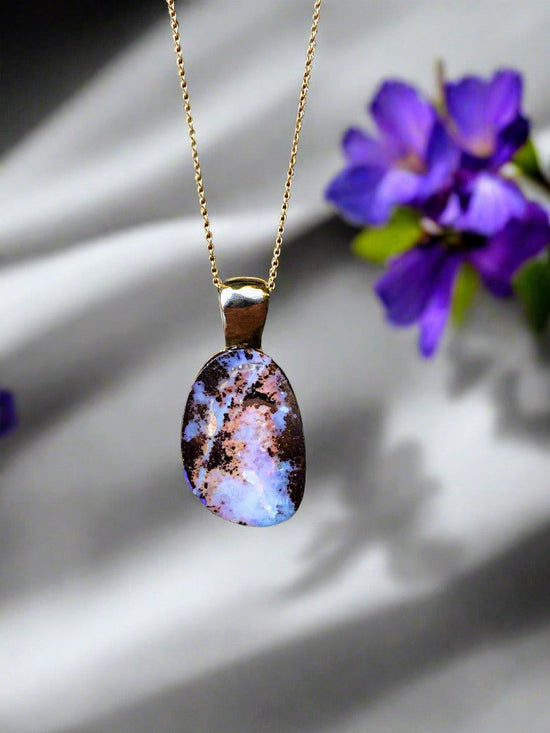 Photo of Boulder Opal Pendant in a decorative scene, designed by , available at Plumb Gold & Plumb Silver