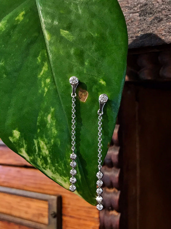 Photo of Breuning Diamond Earring Jackets in a decorative scene, designed by , available at Plumb Gold & Plumb Silver