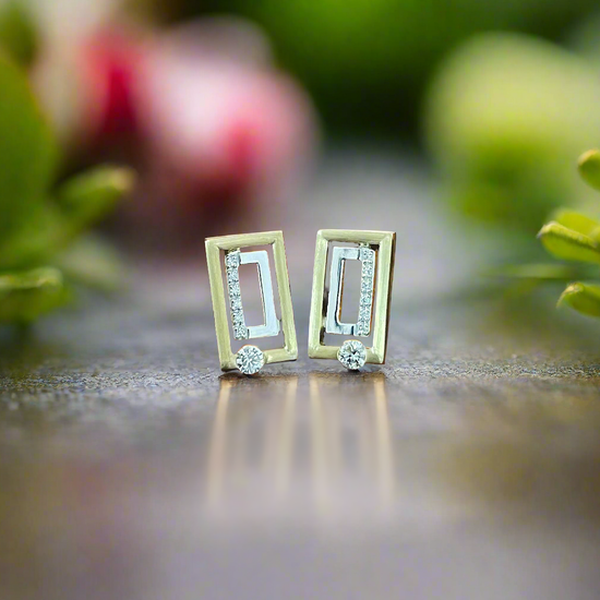 Photo of Breuning Diamond Geometric Studs in a decorative scene, designed by , available at Plumb Gold & Plumb Silver
