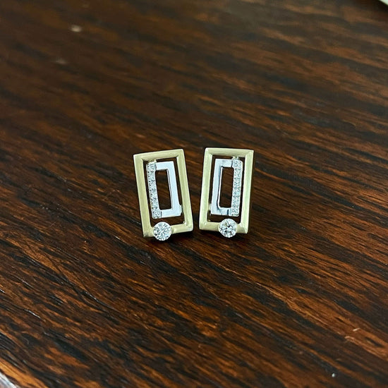 Photo of Breuning Diamond Geometric Studs in a decorative scene, designed by , available at Plumb Gold & Plumb Silver