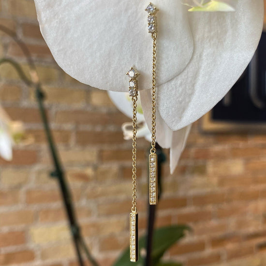 Photo of Breuning Diamond Stick Dangle Stud Earrings in a decorative scene, designed by , available at Plumb Gold & Plumb Silver
