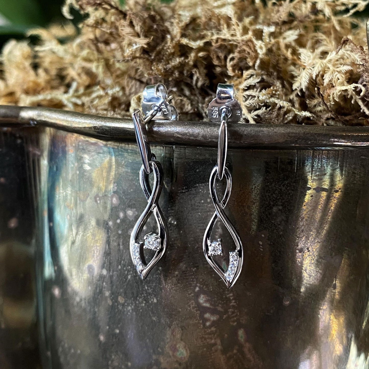 Photo of Breuning  Diamond Twist Earring in a decorative scene, designed by , available at Plumb Gold & Plumb Silver
