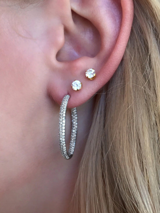 Photo of Breuning In and Out Diamond Hoops in a decorative scene, designed by , available at Plumb Gold & Plumb Silver
