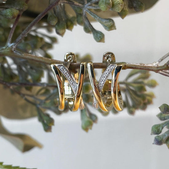 Photo of Breuning Wide "X" Huggies in a decorative scene, designed by , available at Plumb Gold & Plumb Silver