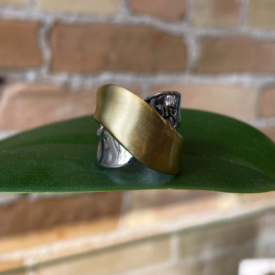 Photo of “Bridge” Ring in a decorative scene, designed by , available at Plumb Gold & Plumb Silver