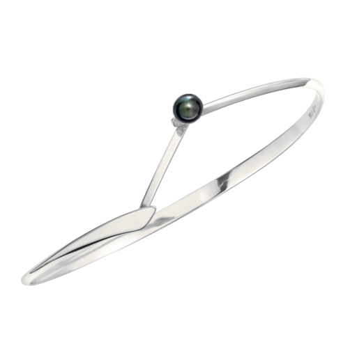 Photo of "Button" Swing Bracelet in a decorative scene, designed by , available at Plumb Gold & Plumb Silver