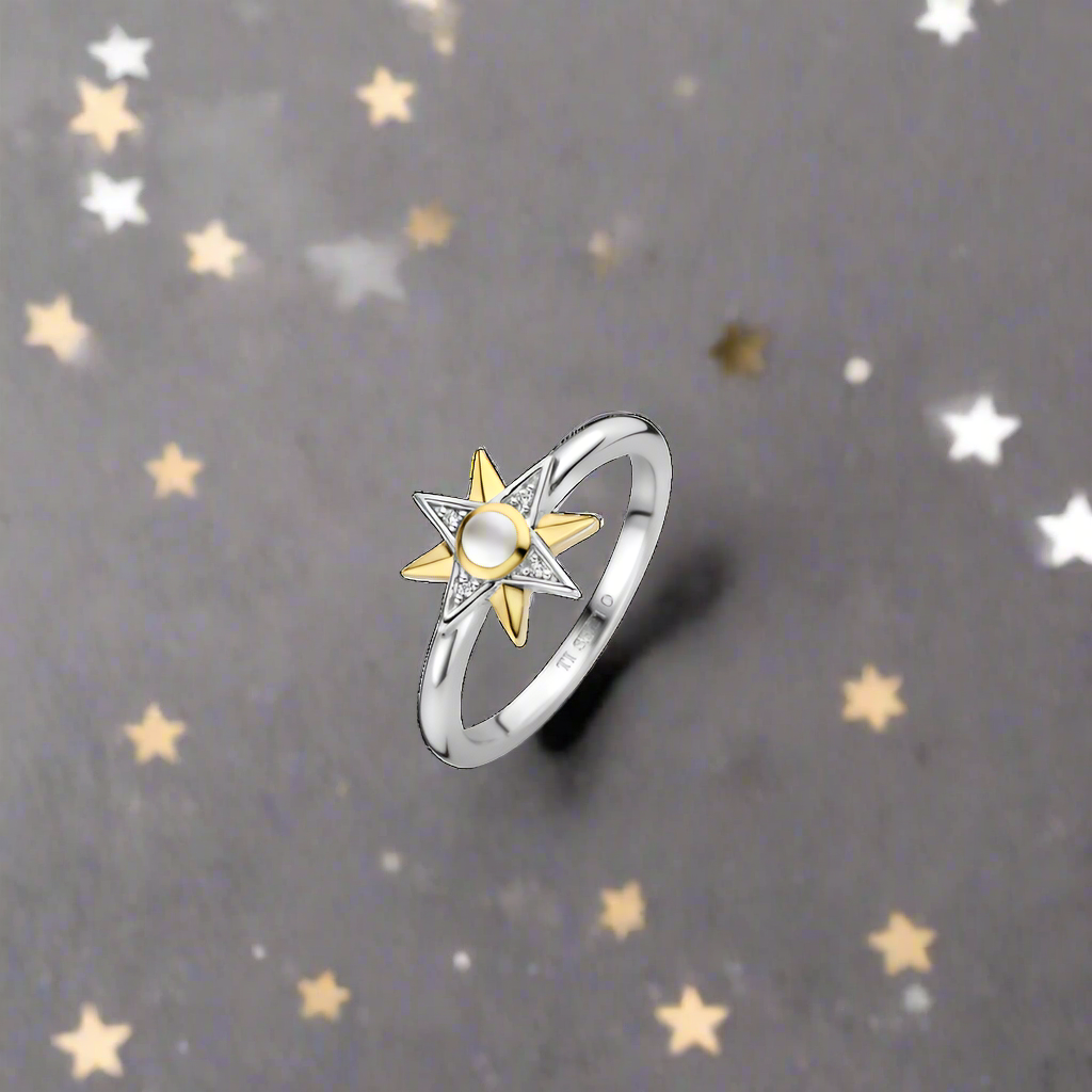 Photo of Celestial Star Ring in a decorative scene, designed by , available at Plumb Gold & Plumb Silver