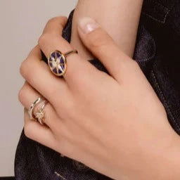 Photo of Celestial Star Ring in a decorative scene, designed by , available at Plumb Gold & Plumb Silver