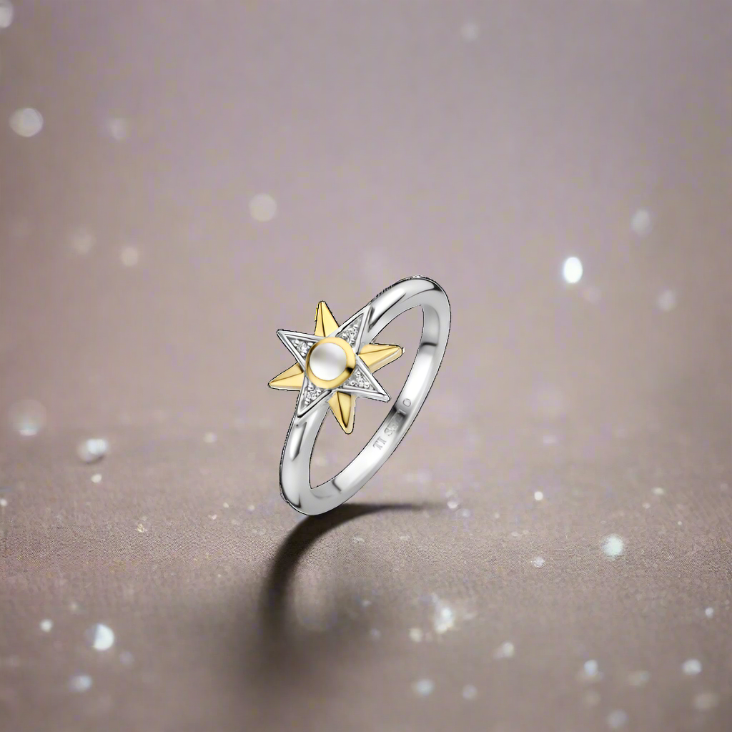 Photo of Celestial Star Ring in a decorative scene, designed by , available at Plumb Gold & Plumb Silver