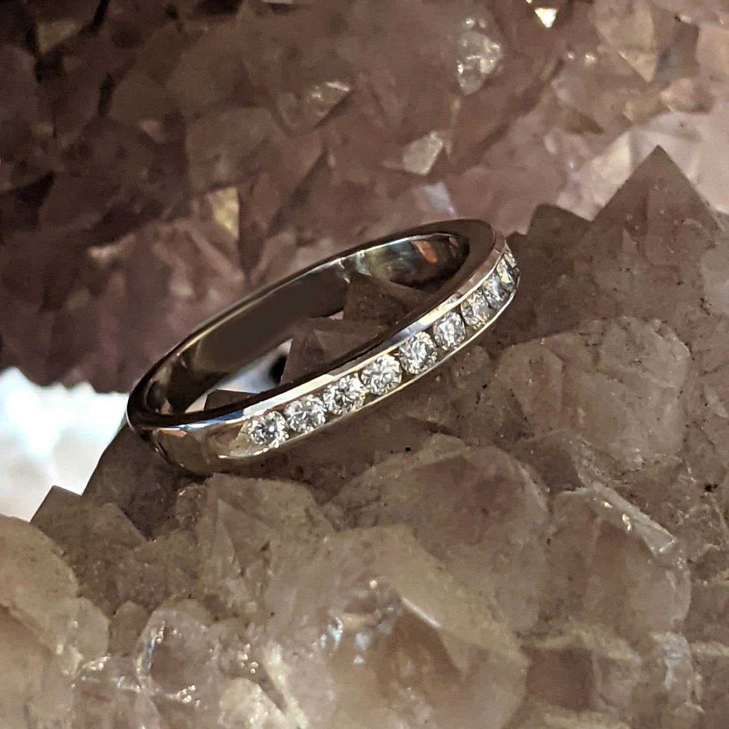 Photo of Channel Set Diamond Ring in a decorative scene, designed by , available at Plumb Gold & Plumb Silver
