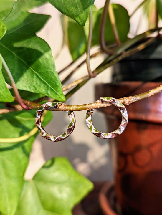 Photo of Chevron circle earrings in a decorative scene, designed by , available at Plumb Gold & Plumb Silver